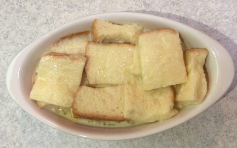 Pour the mixture evenly over the bread