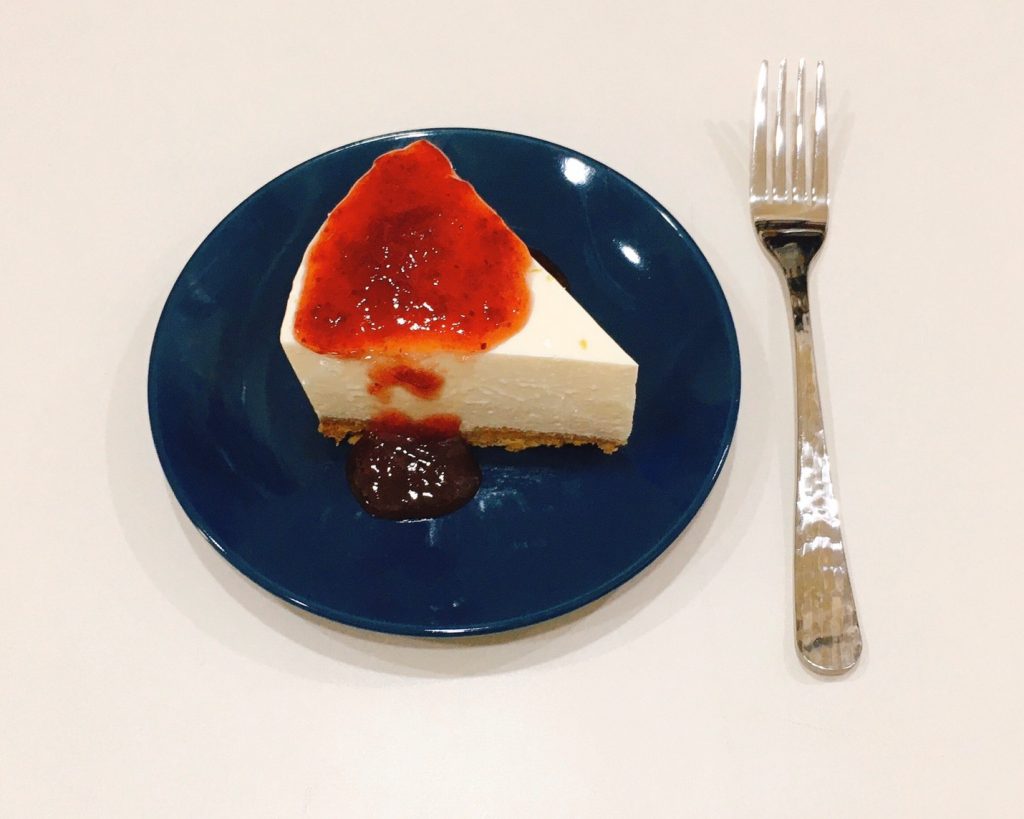 low carb keto lemon cheesecake with strawberry sauce.